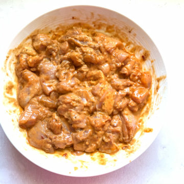 2. Marinated Chicken for Chilli Chicken Recipe- Piping Pot Curry Marinated Chicken in a white bowl