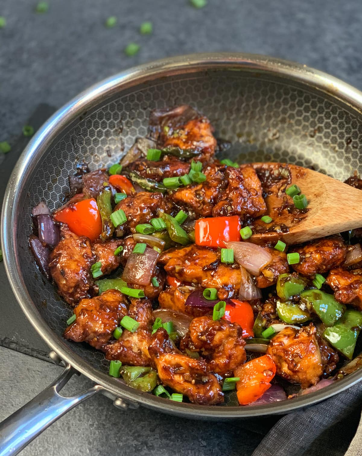 Chilli Chicken with onions and peppers in a pan