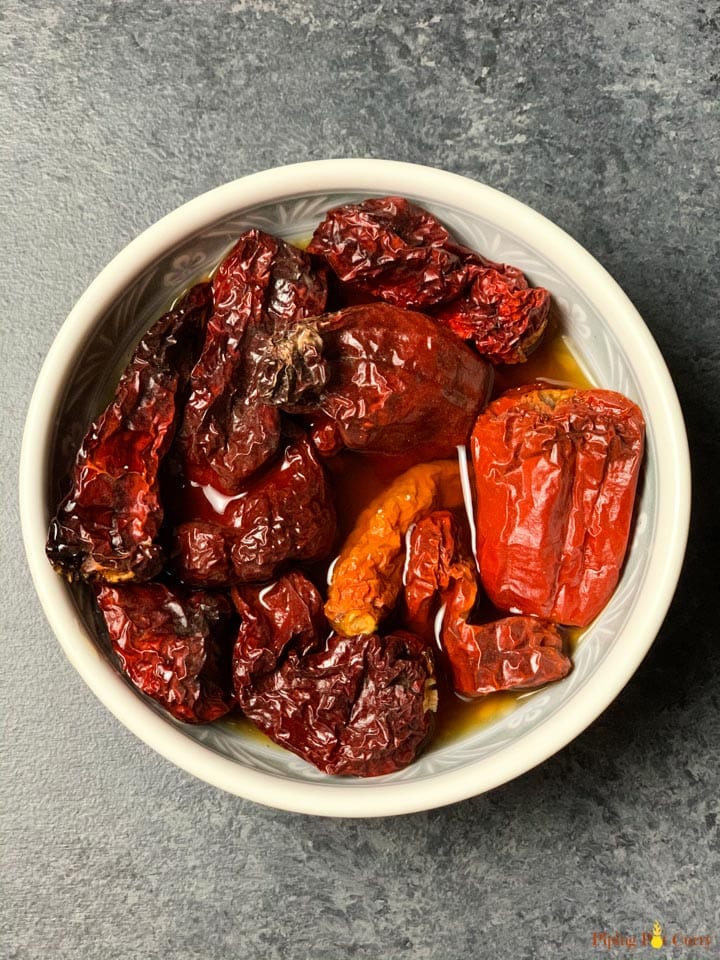 Soaked Kashmiri red chilli in a white bowl