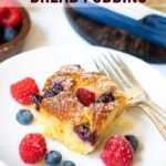 Air Fryer Berry Bread pudding served in a white plate with fresh berries on the side