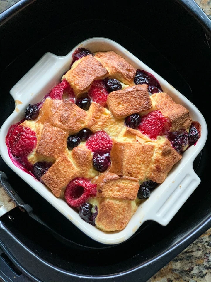 Bread pudding with berries in an air fryer basket