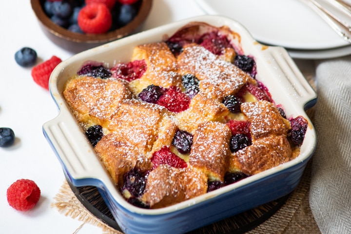 bread pudding with fresh berries in a square bowl
