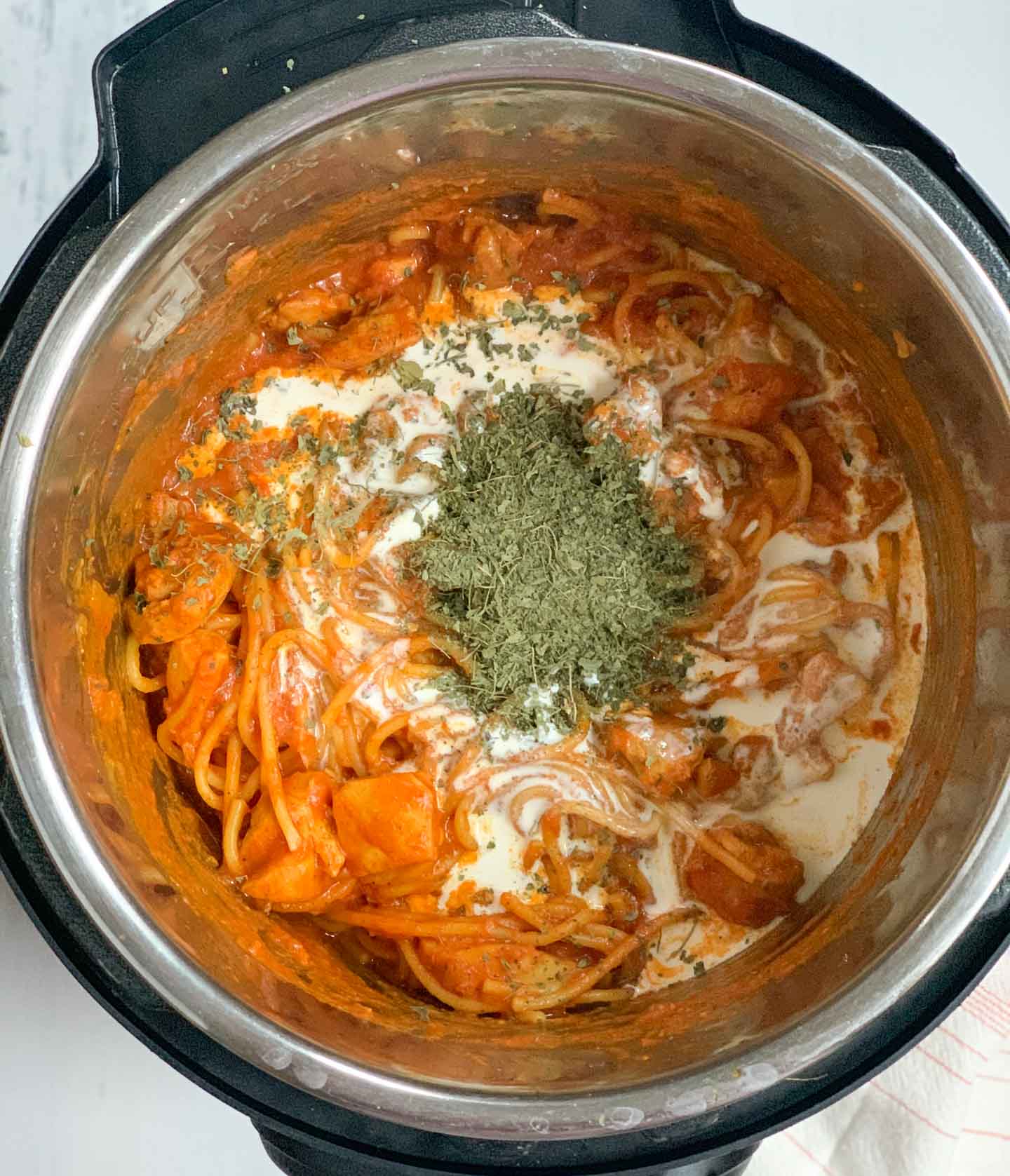 Chicken Tikka Masala Pasta Step 4 - finish with cream Piping Pot Curry Cooked Spaghetti topped with cream and crushed fenugreek leaves