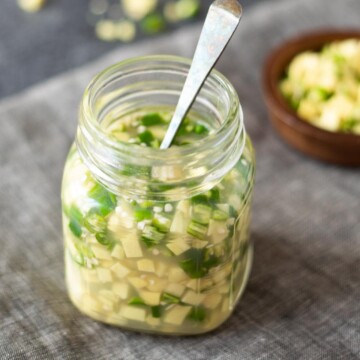 Adrak ka achar. Ginger green chili pickle in a glass bottle