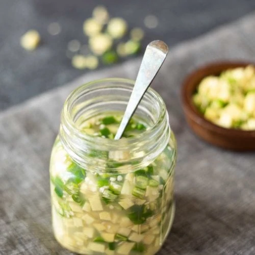 Ginger green chili pickle in a glass bottle