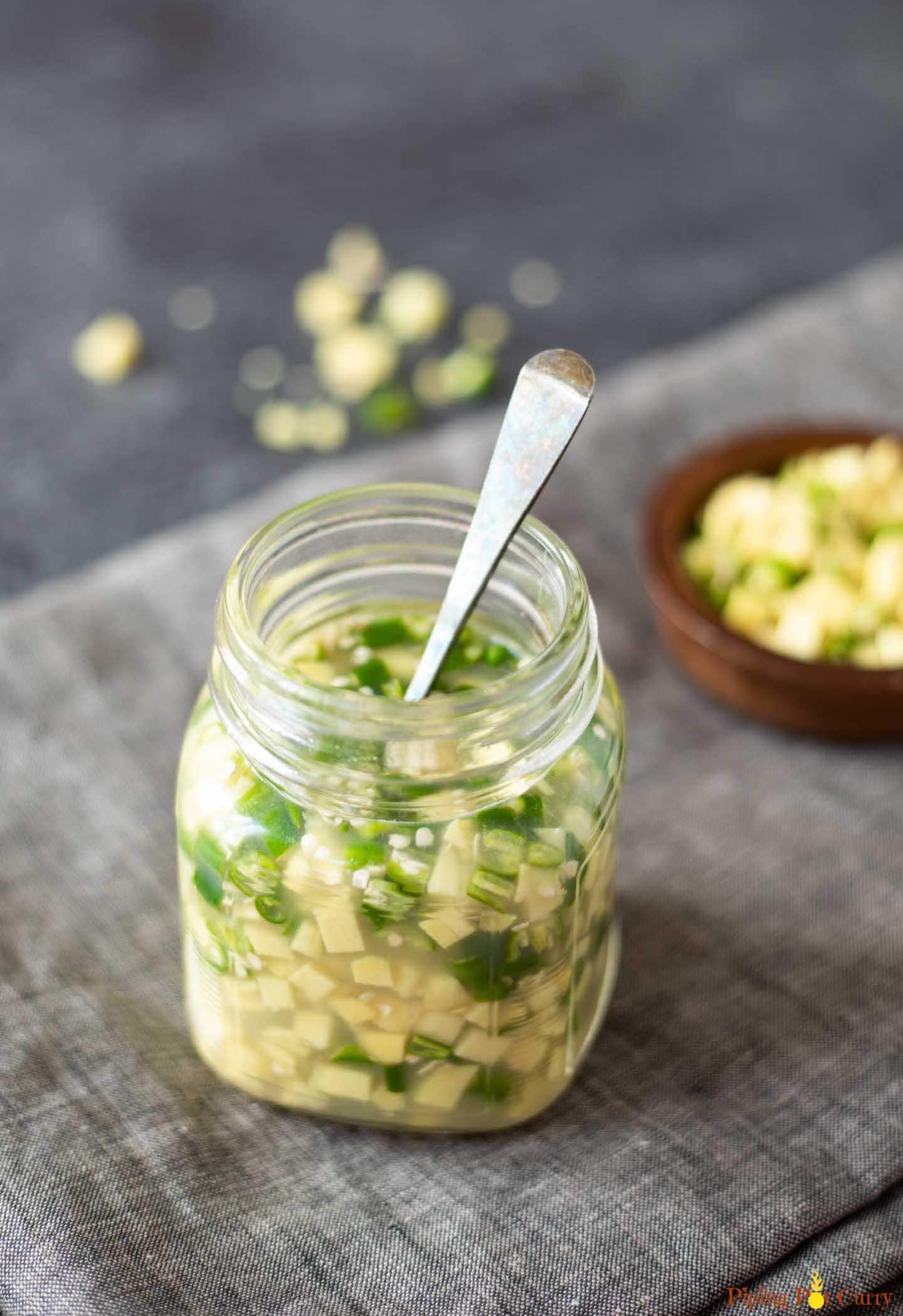 Ginger green chili pickle in a glass bottle