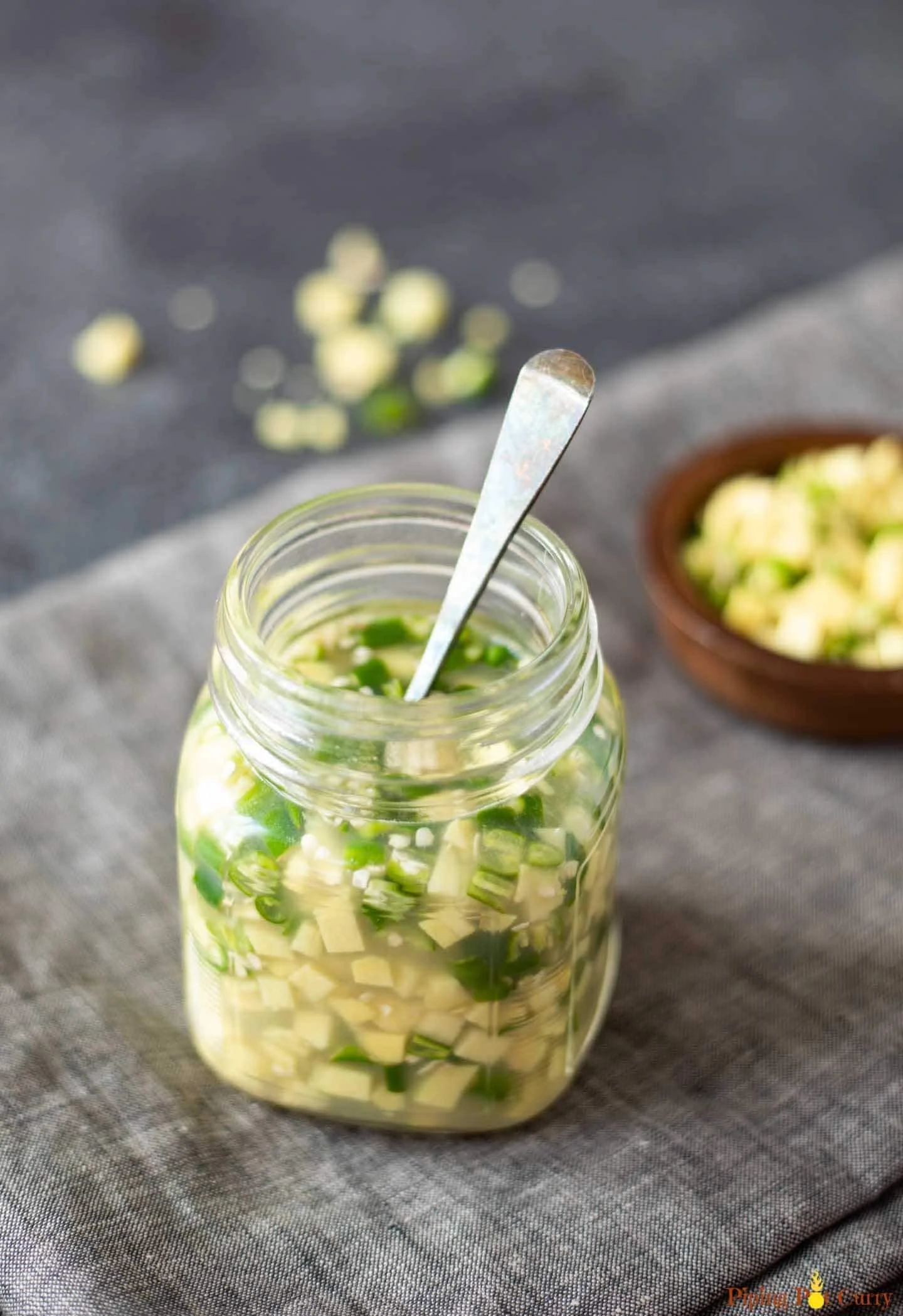 Ginger green chili pickle in a glass bottle