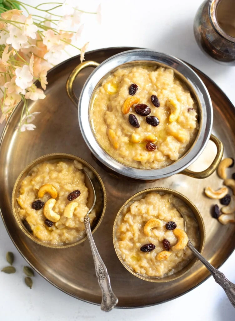 Sweet Pongal garnished with cashews and raisins served in bowls