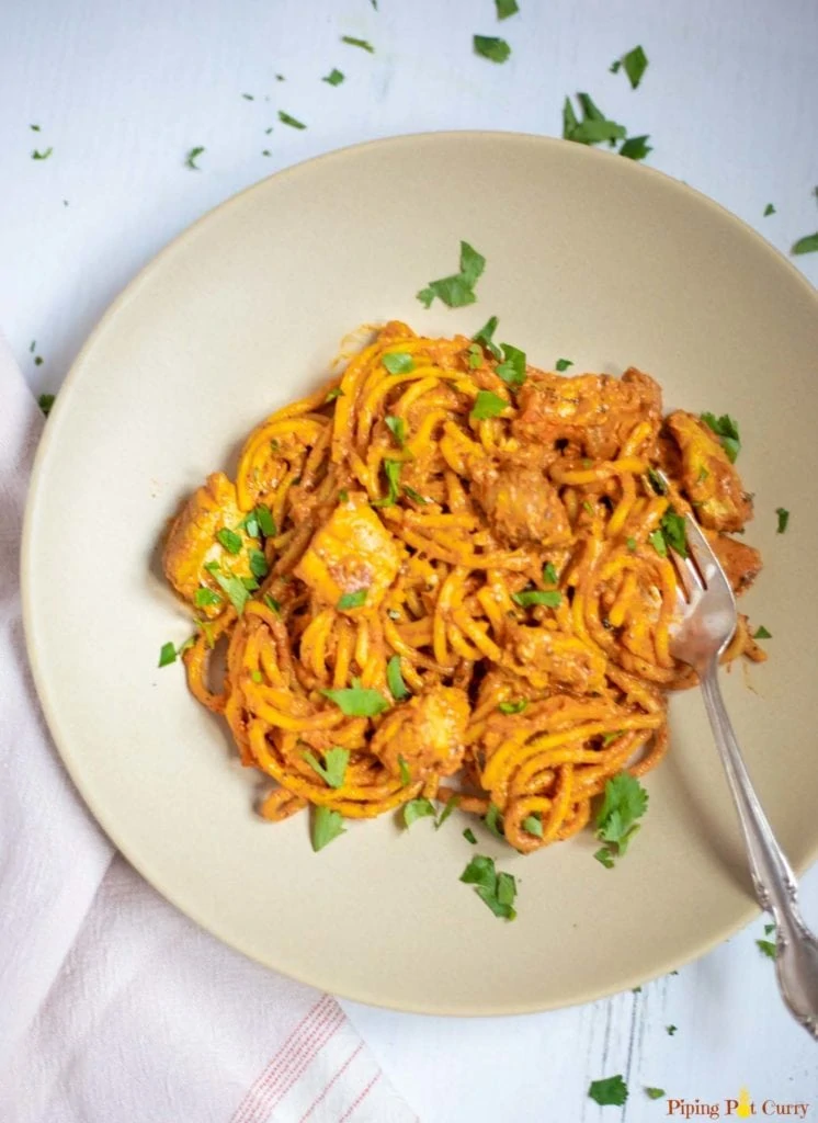 Chicken Spaghetti pasta in a plate garnished with cilantro