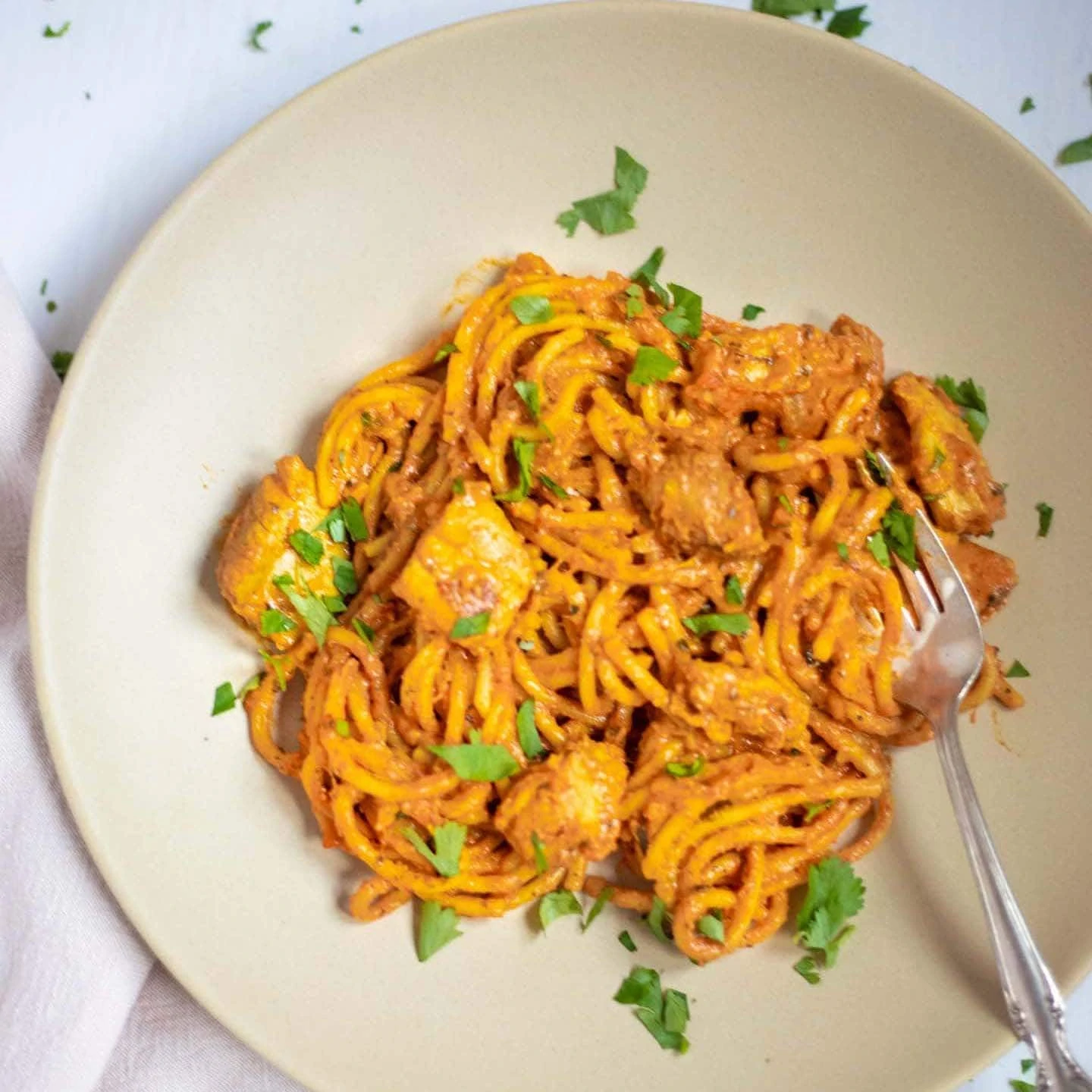 Chicken Spaghetti pasta in a plate garnished with cilantro