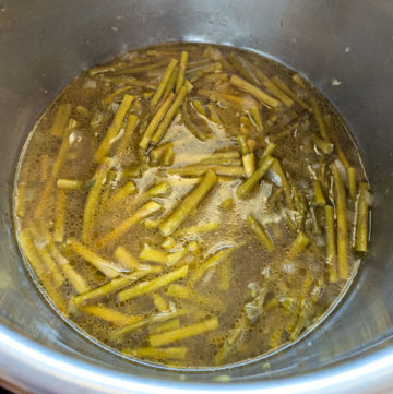 Cooked asparagus in broth in instant pot steel insert