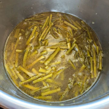 Cooked asparagus in broth in instant pot steel insert