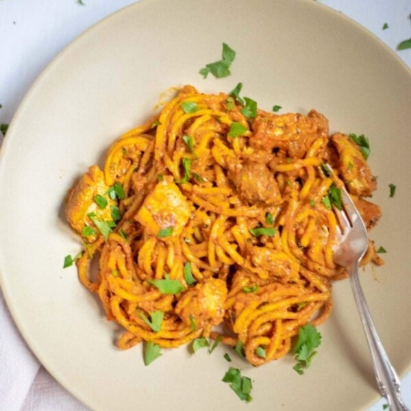 Chicken Spaghetti pasta in a plate garnished with cilantro