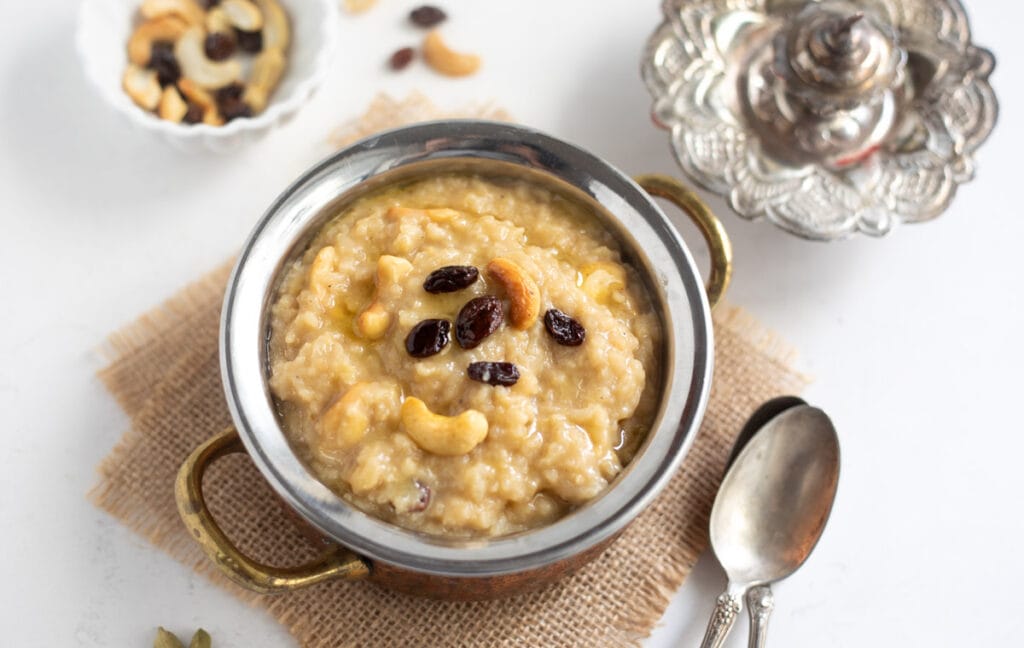 Sakkarai Pongal served in a pretty brass bowl topped with roasted cashews and raisins 