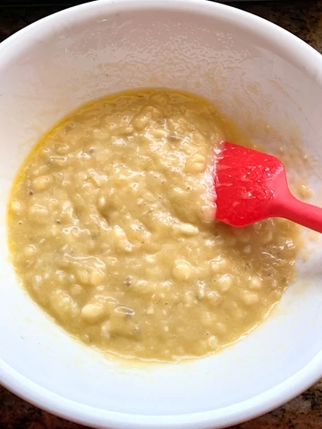 Mashed bananas in a white bowl