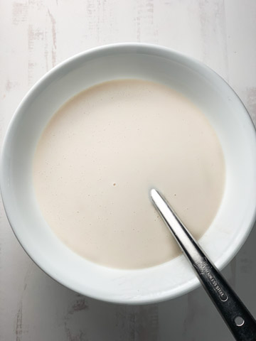 Paneer Frankie Recipe Steps - Piping Pot Curry-1 All-porpose flour batter in a white bowl