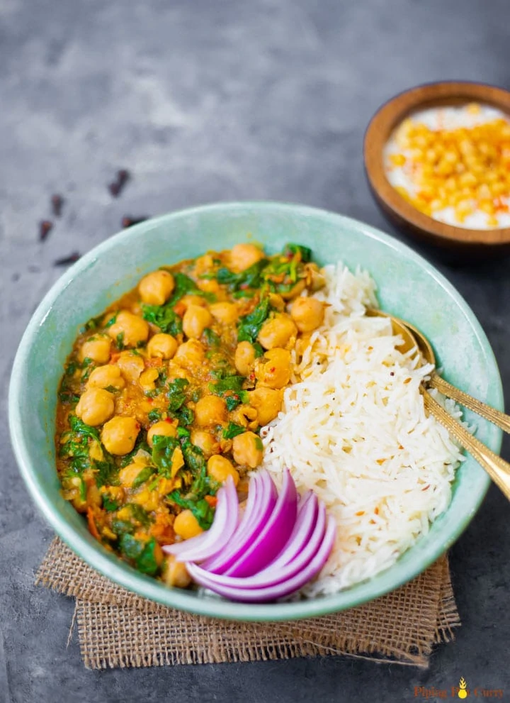 Chickpea and spinach curry with white basmati rice and onions 