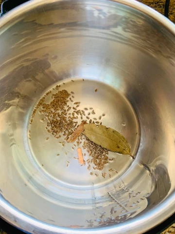 instant pot chickpea curry with spinach steps - Piping Pot Curry-1 Whole spices on oil in the instant pot