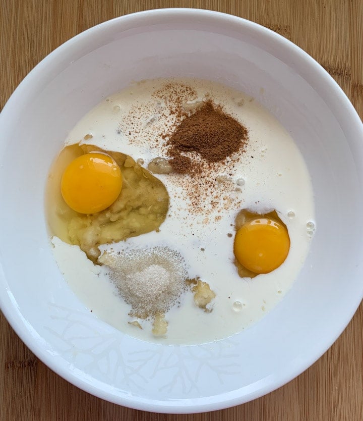 Banana Bread Pudding steps - Piping Pot Curry-3 Wet ingredients such as egg, creamy,, cinnamon and sugar in a white bowl