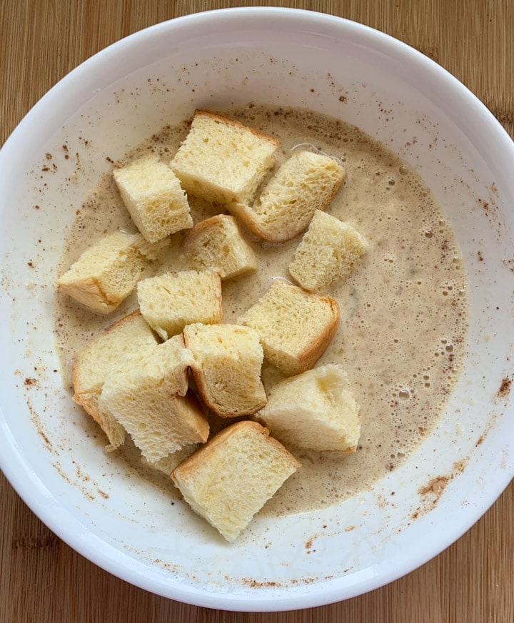 Banana Bread Pudding steps - Piping Pot Curry-4 Brioche squares in custard in a white bowl