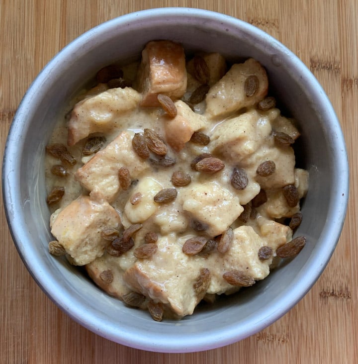 Banana Bread Pudding steps - Piping Pot Curry-6 bread pudding topped with raisins in a round baking pan