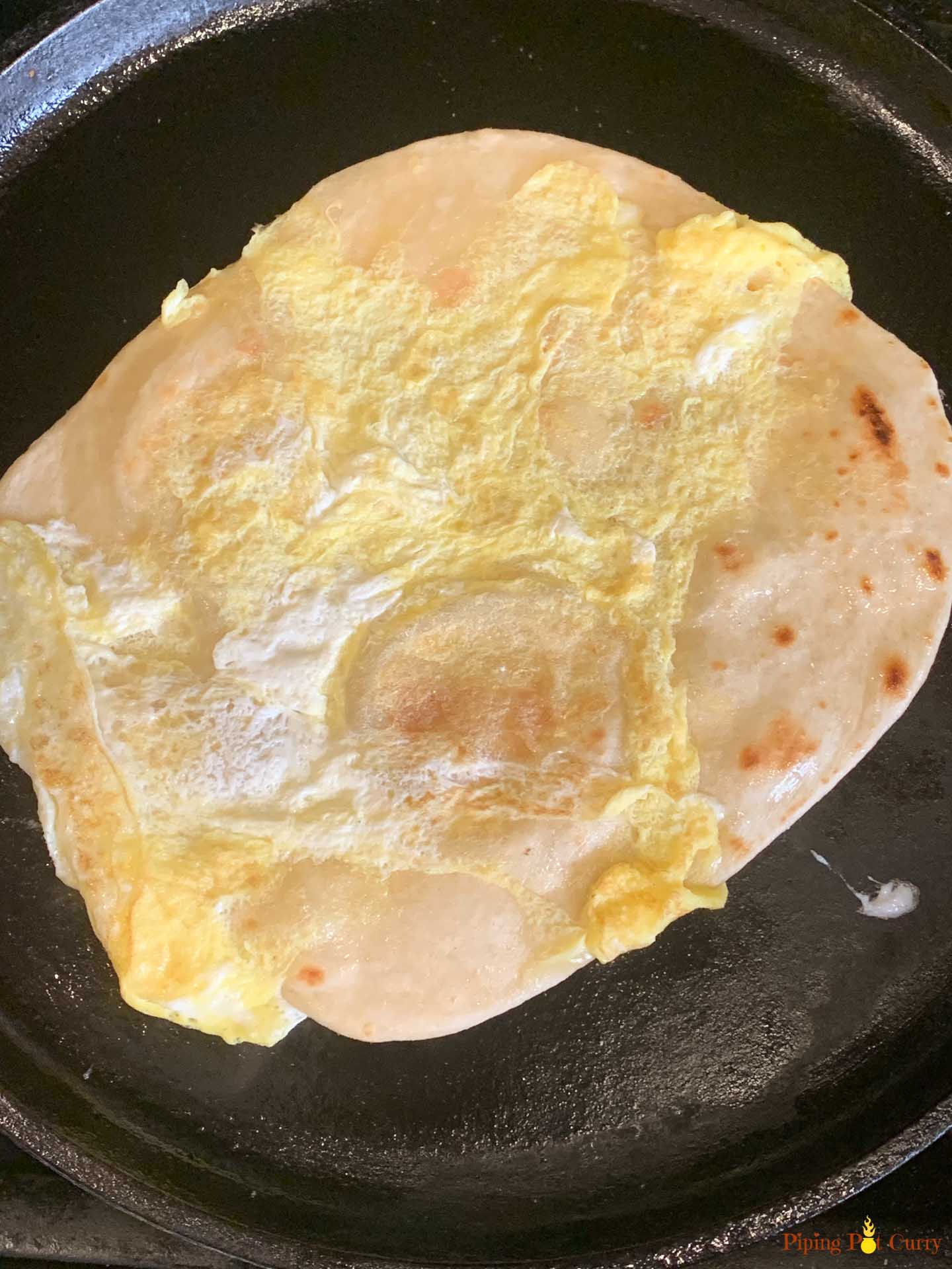 Paneer Kathi Roll - Piping Pot Curry-5 Frankie Flatbread with egg cooked on a cast iron pan