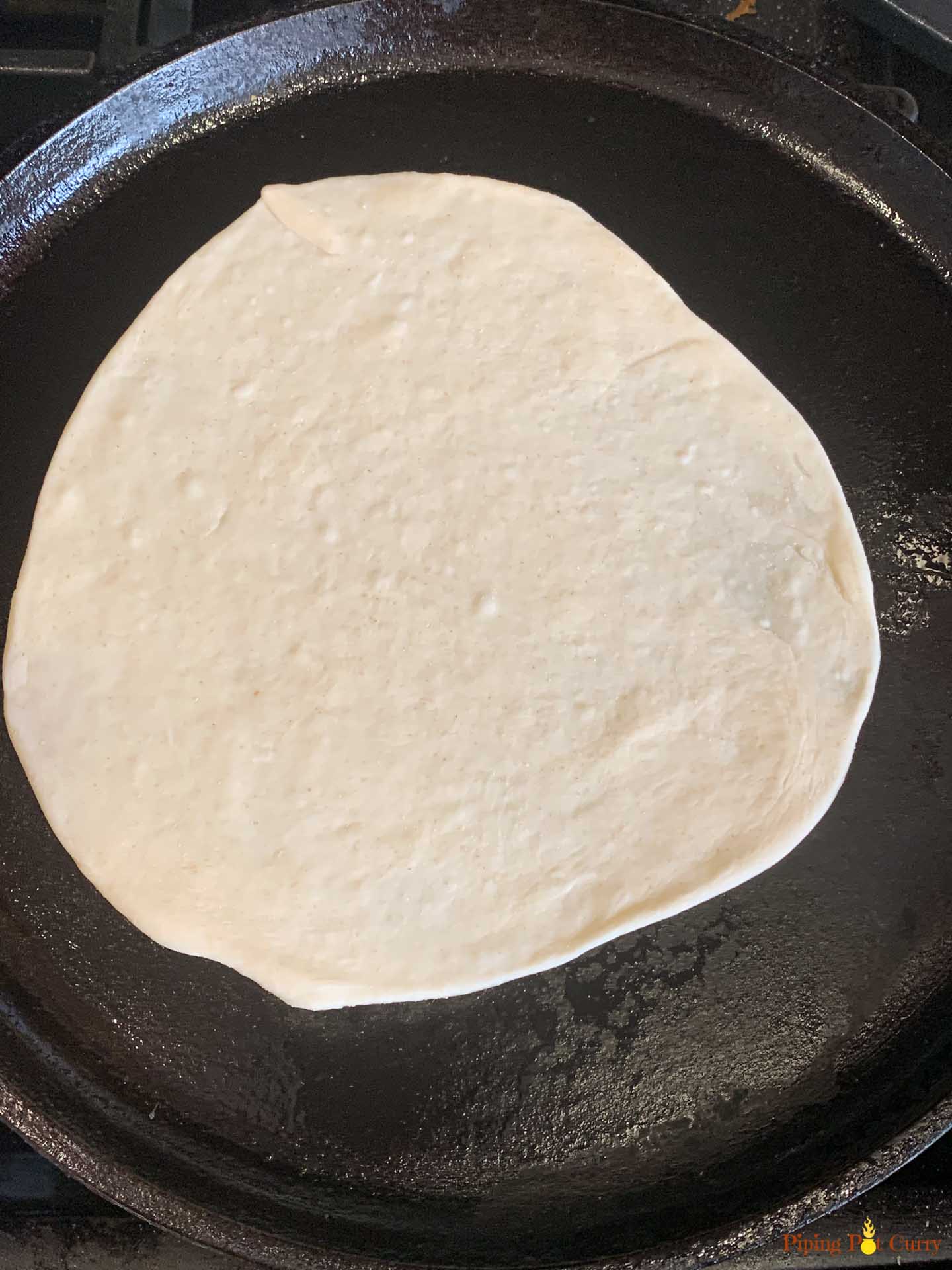 Paneer Kathi Roll - Piping Pot Curry-6 Rolled Flatbread on a cast iron pan