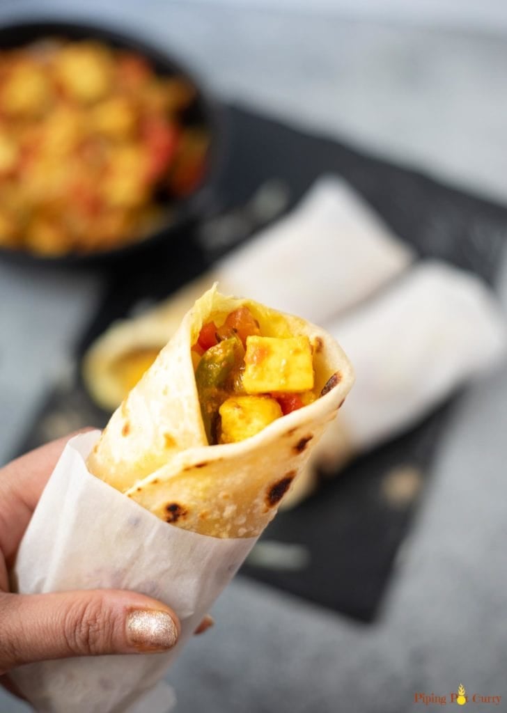 Paneer Frankie Roll in hand with some more Kathi Rolls in the back