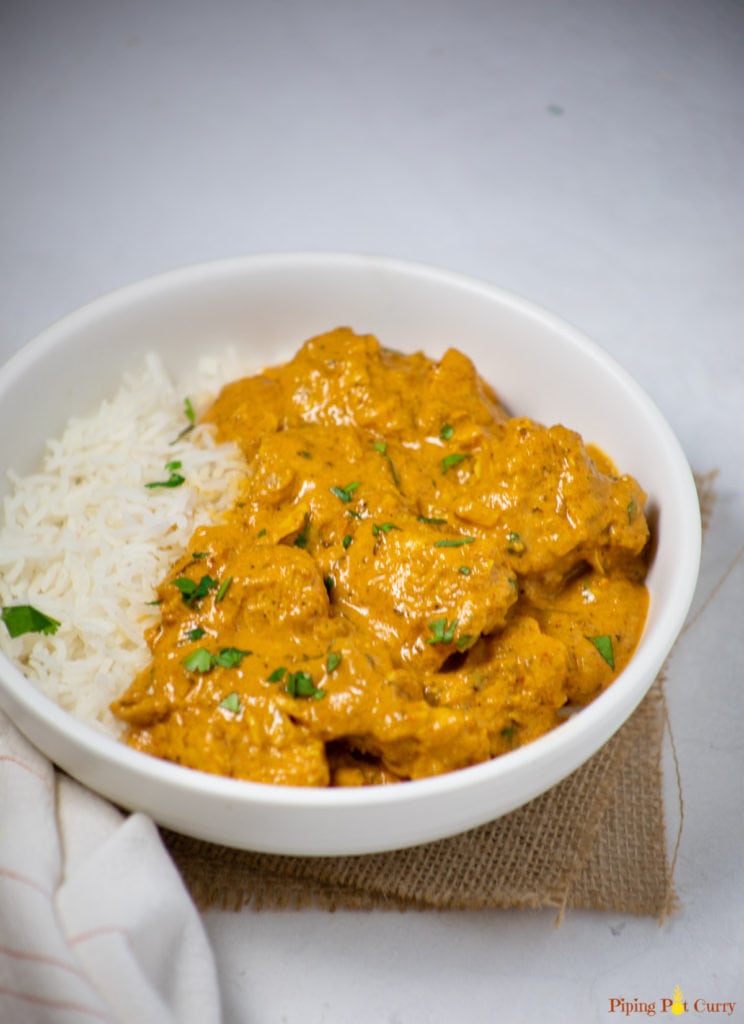 Coconut Chicken Curry served over rice in a white bowl