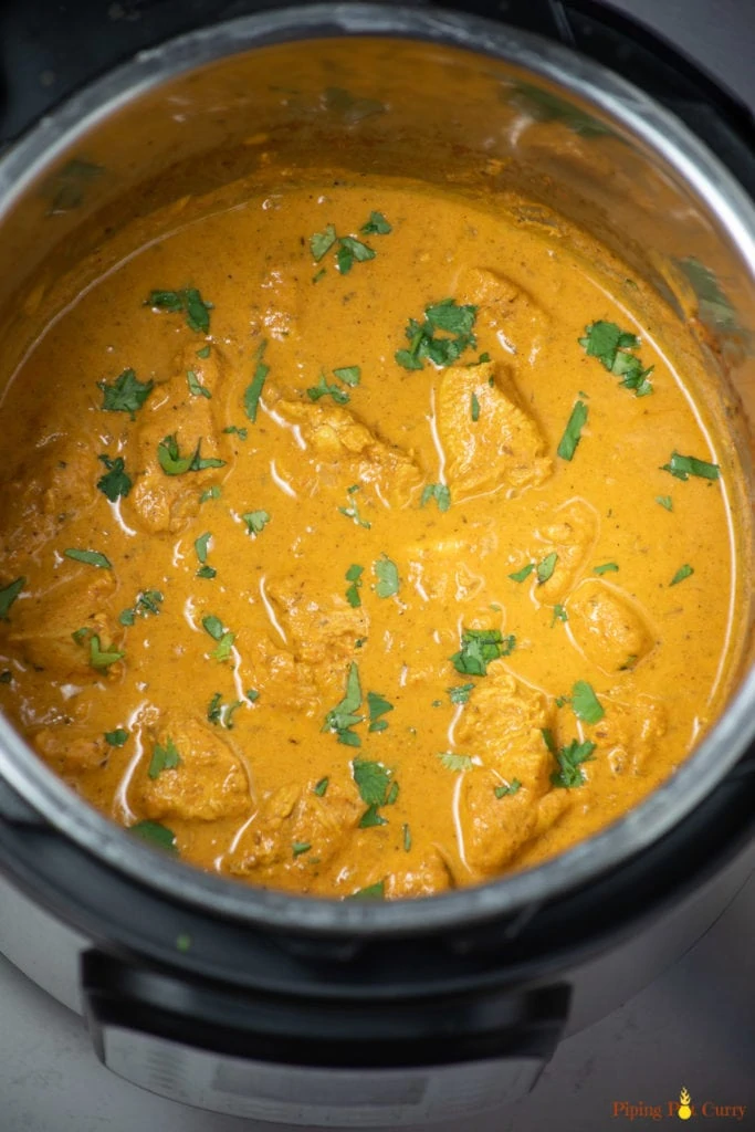 Chicken Curry with coconut milk in an instant pot garnished with cilantro