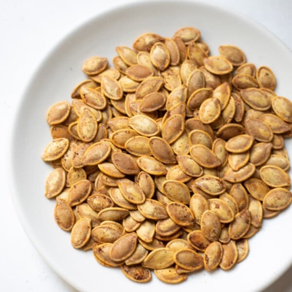 Roasted pumpkin seeds in a white plate