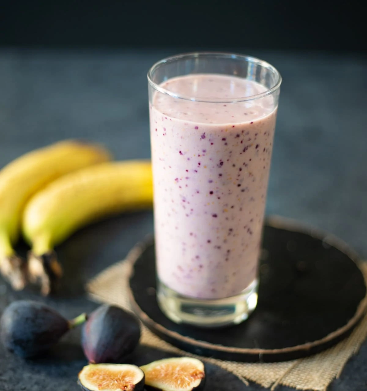 Fig Banana Smoothie in a glass with the ingredients around the glass