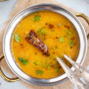 Gujarati Dal in a hand bowl garnished with cilantro