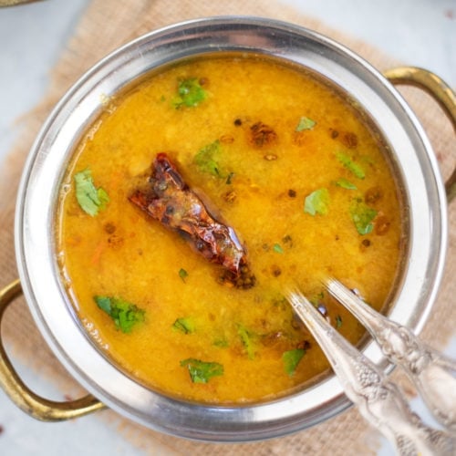Gujarati Dal in a hand bowl garnished with cilantro