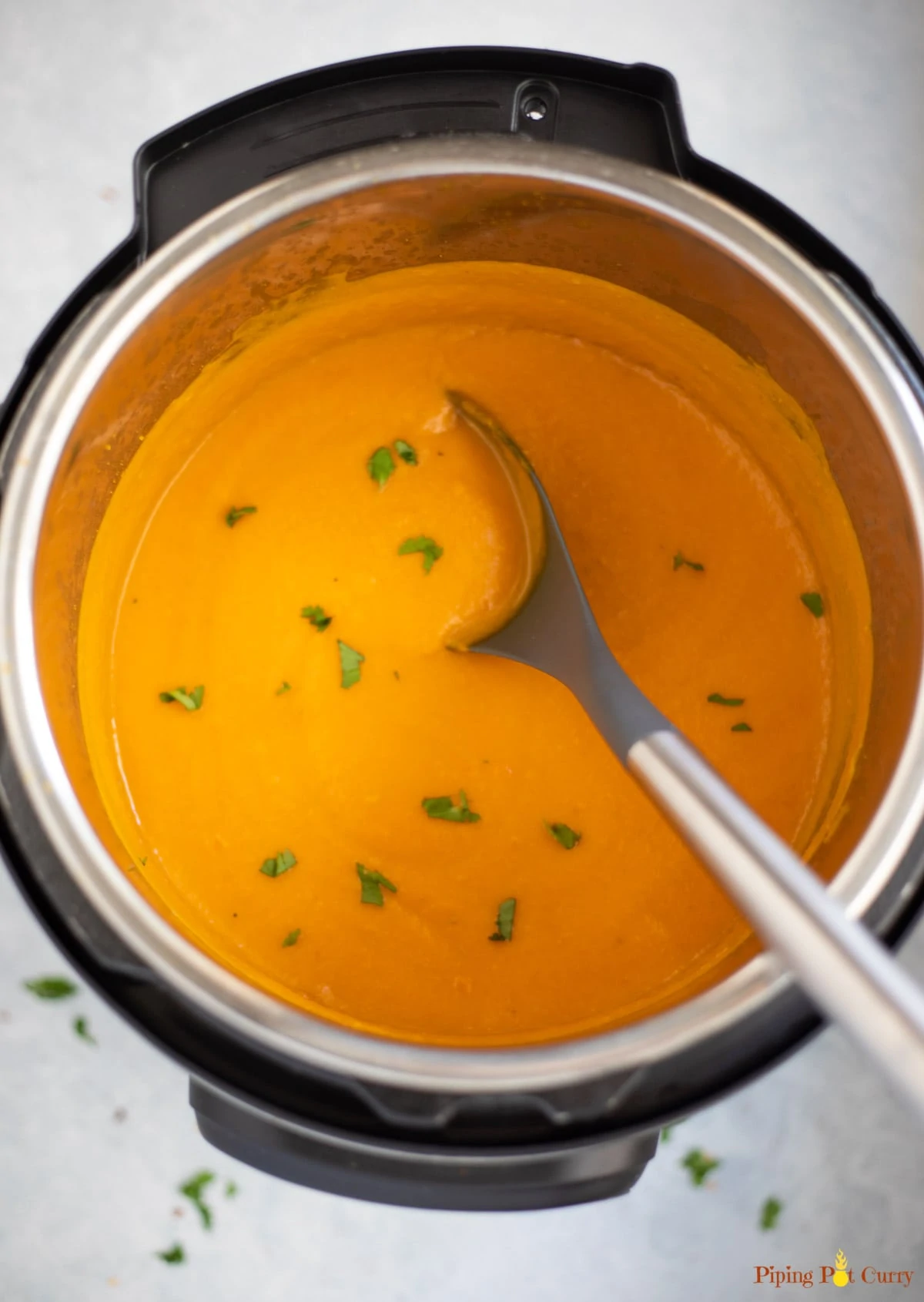 Carrot soup garnished with cilantro in the instant pot