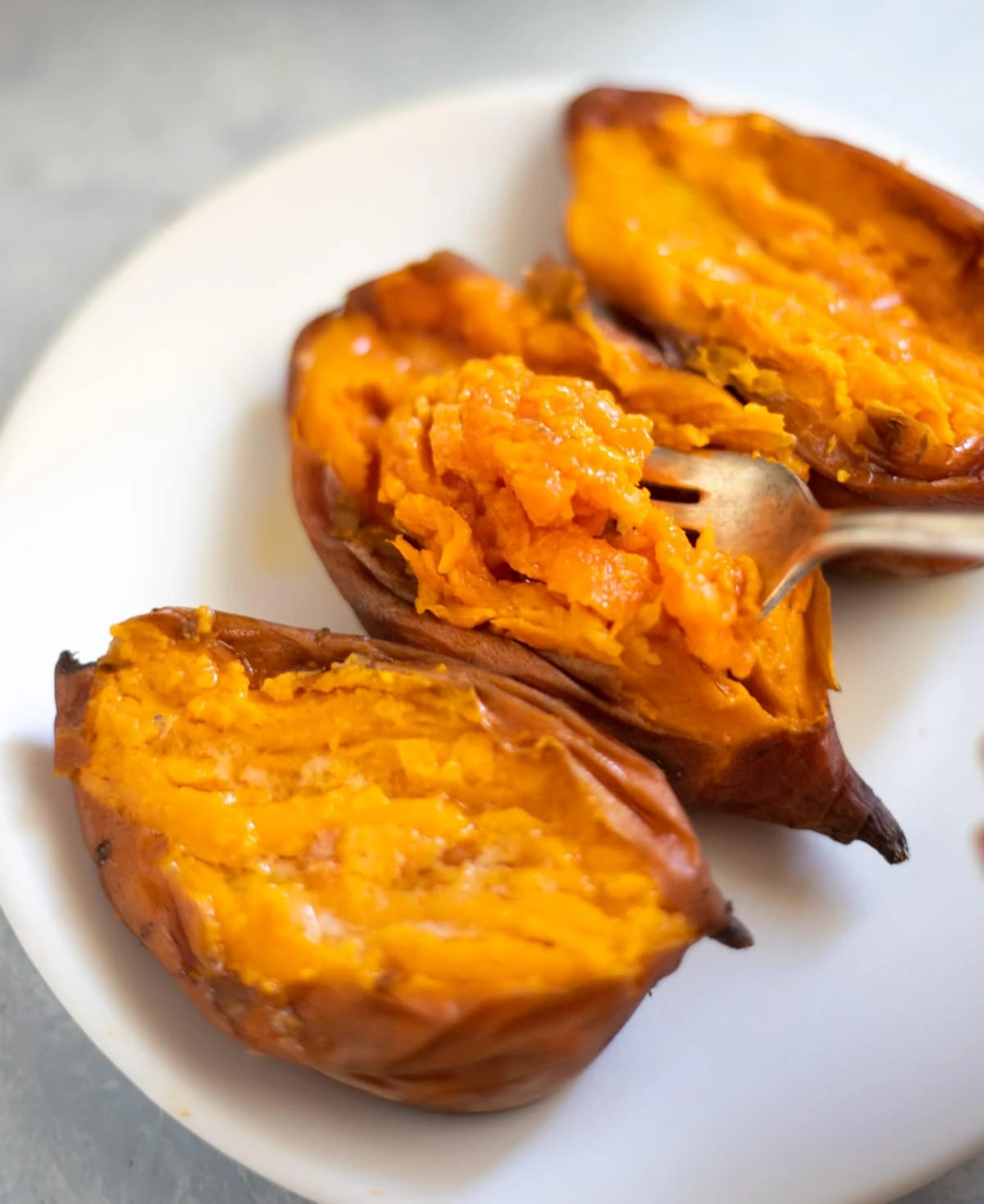 Tender creamy sweet potato flesh in a fork