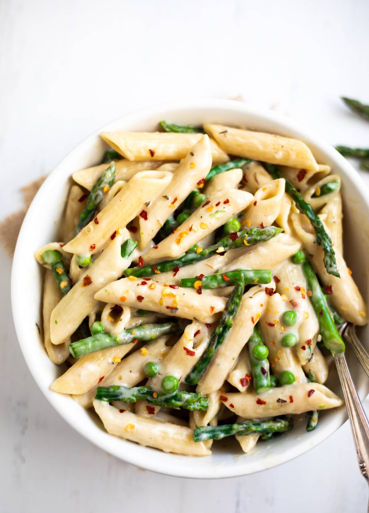 spring looking green asparagus and peas pasta in a bowl