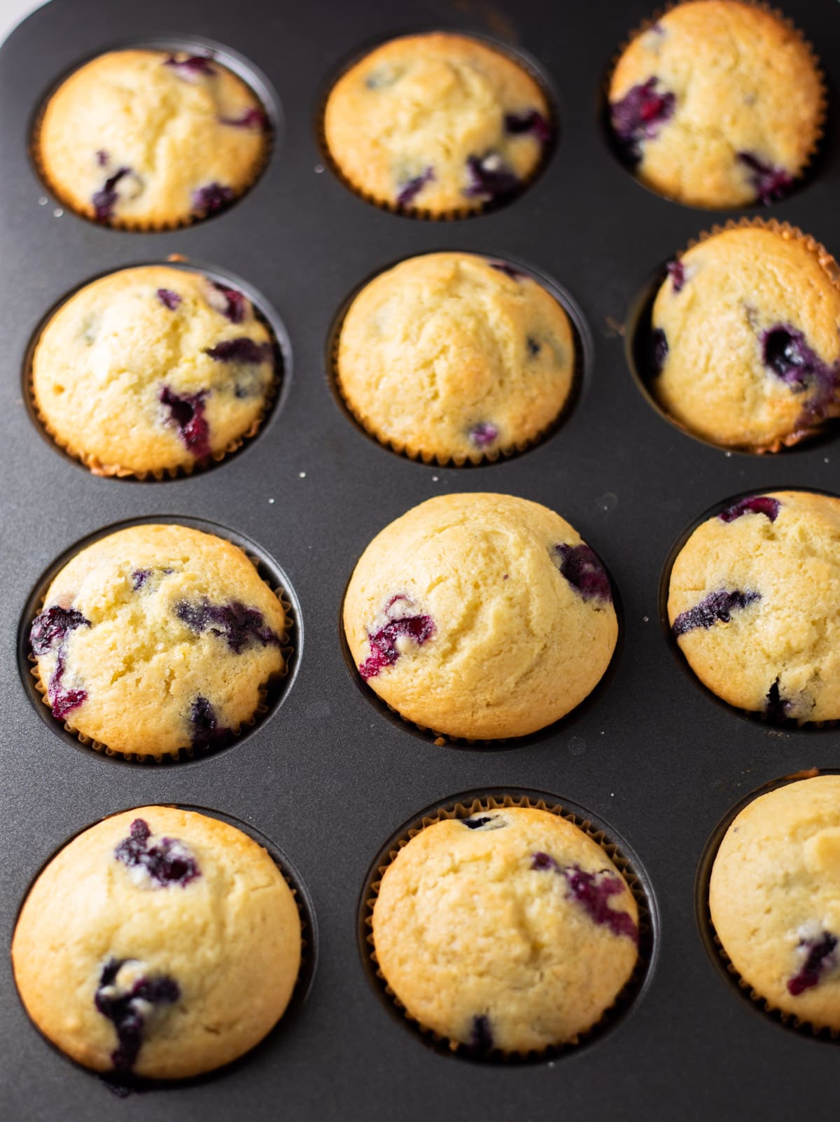Blueberry muffins baked in a 12-count muffin pan