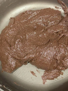 Mixture of condensed milk, cocoa powder and almond flour in a pan