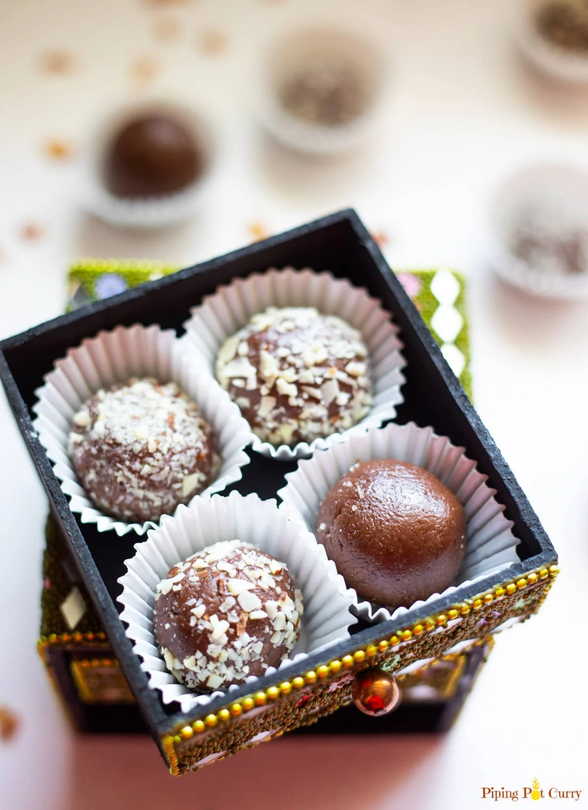 Four Chocolate Ladoo balls In a small decorated box