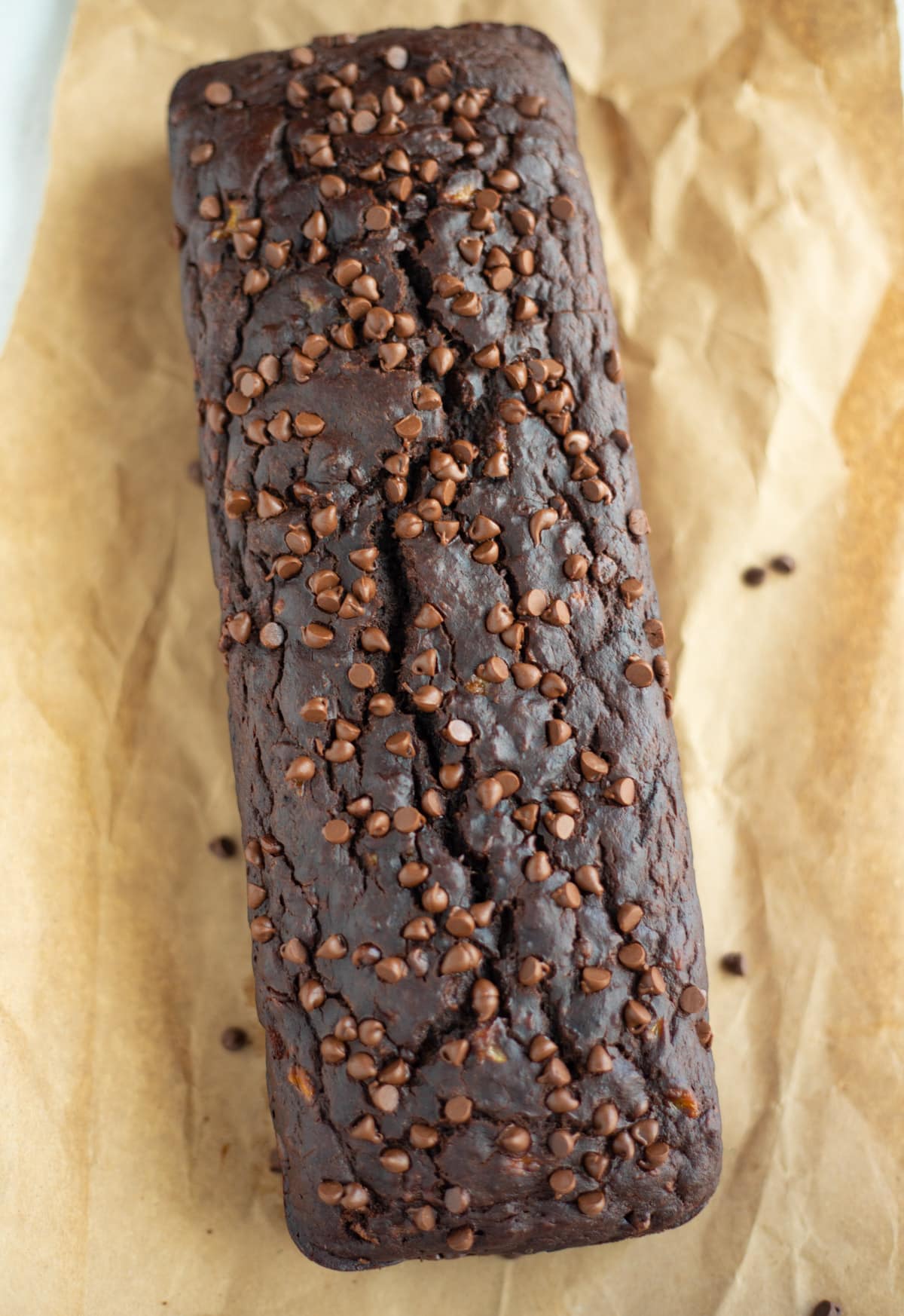 double chocolate banana bread with chocolate chips on a parchment paper