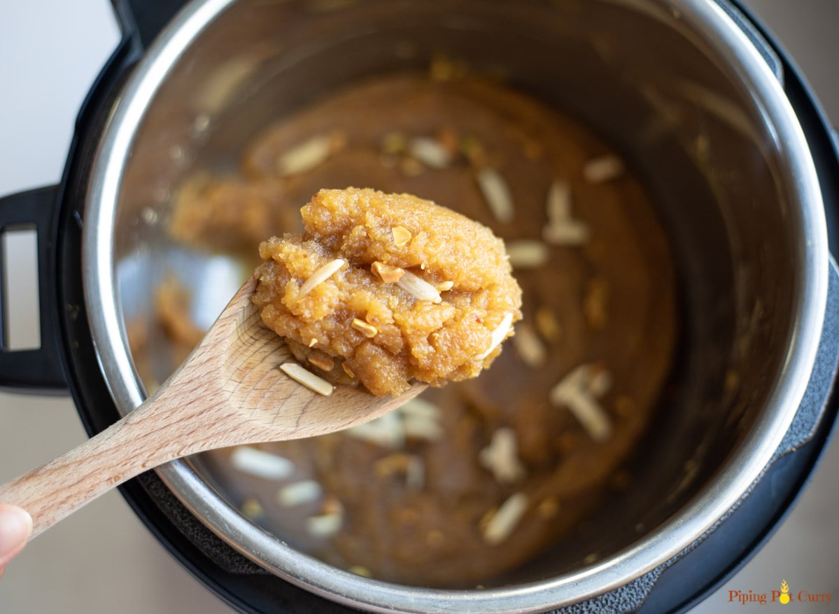 Halwa closeup in a ladle over the pressure cooker