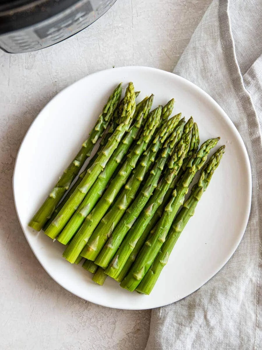 Cooked Asparagus on a white plate
