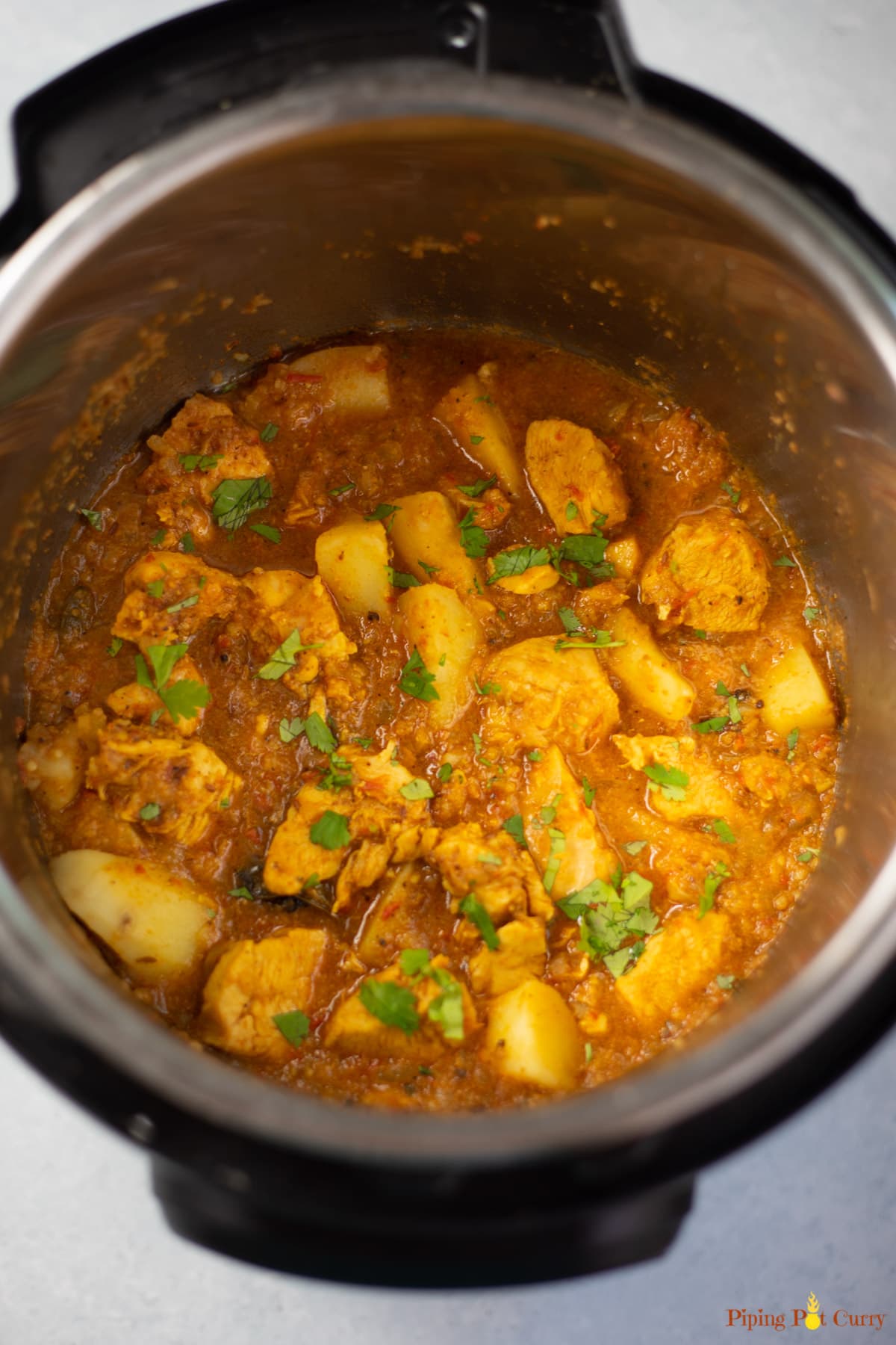 Indian Chicken & potato curry in the instant pot garnished with cilantro