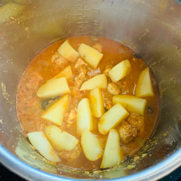 Instant Pot Chicken Potato Curry Steps - Piping Pot Curry-8 Potatoes topped over chicken curry in the instant pot