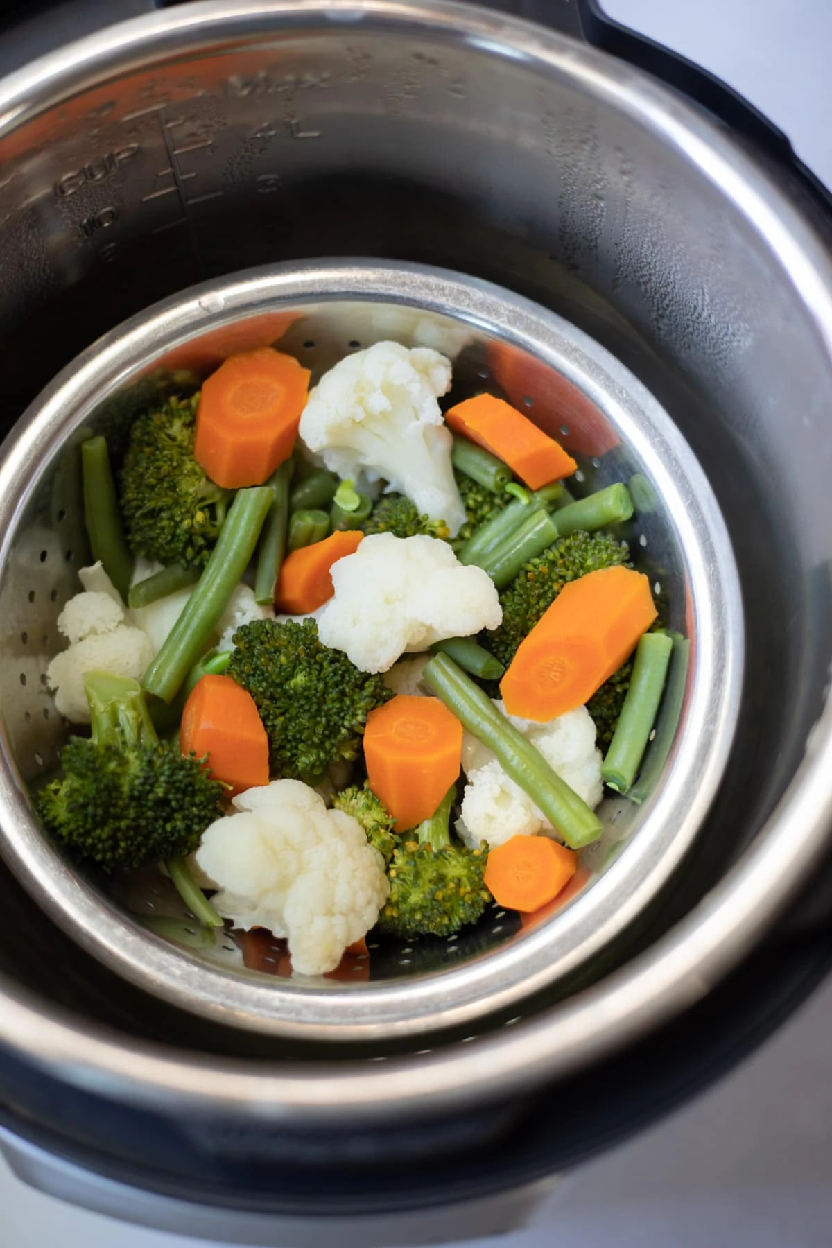 Mixed vegetables in a steamer basket in the instant pot