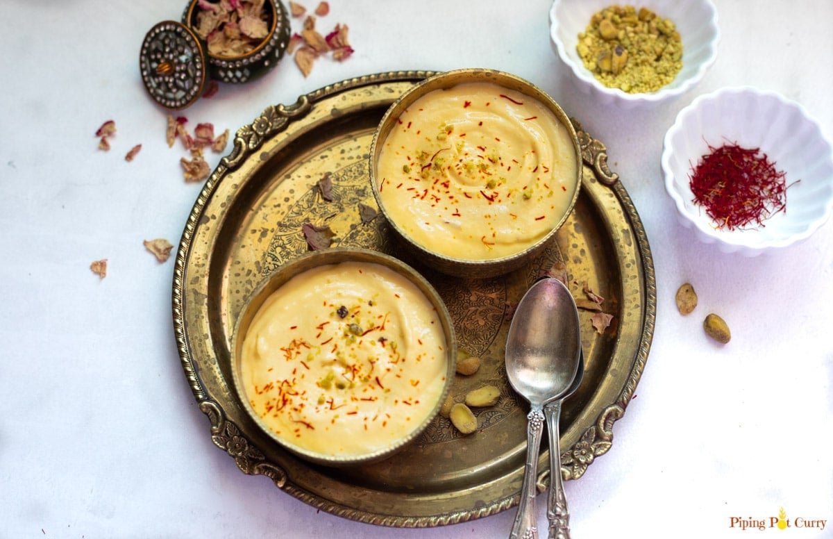 indian mango dessert made with greek yogurt served in 2 pretty bowls 