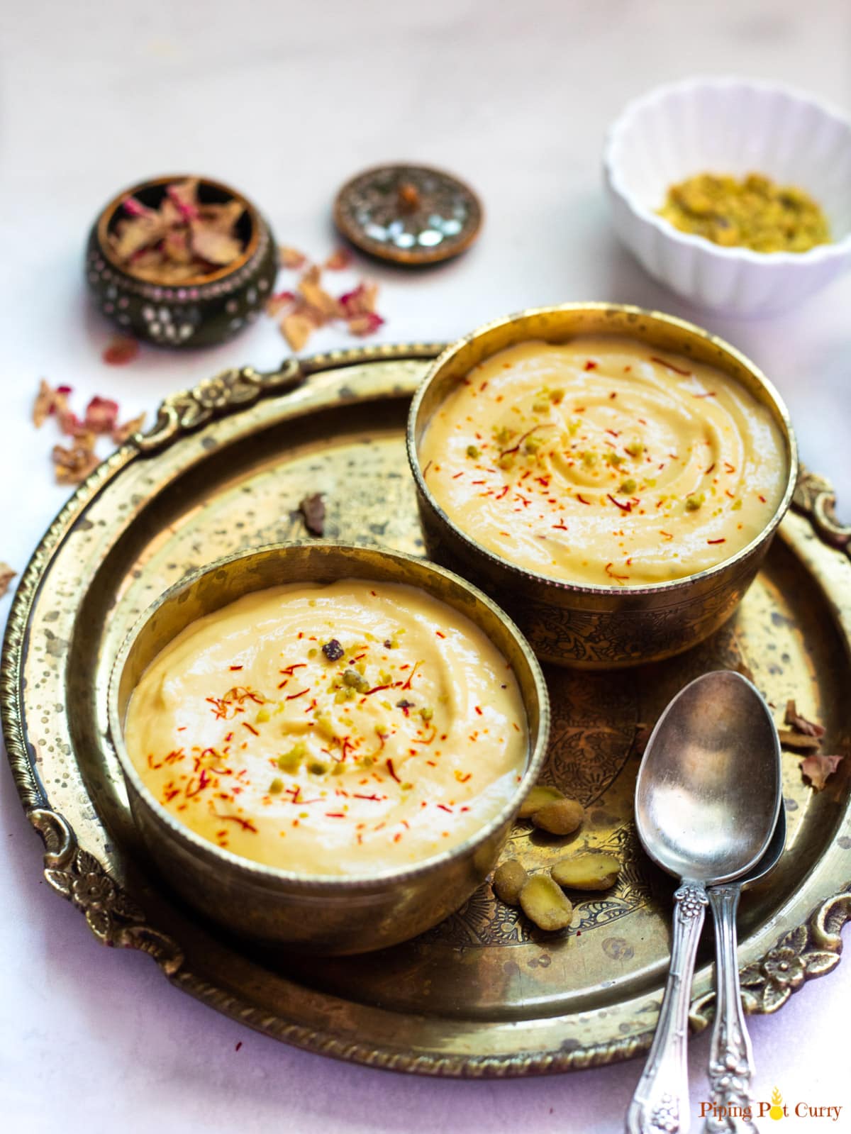 mango shrikhand served in two bowls garnished with saffron