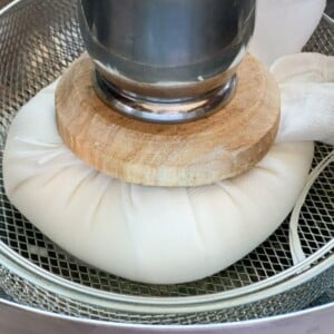 Greek Yogurt being strained to make hung curd