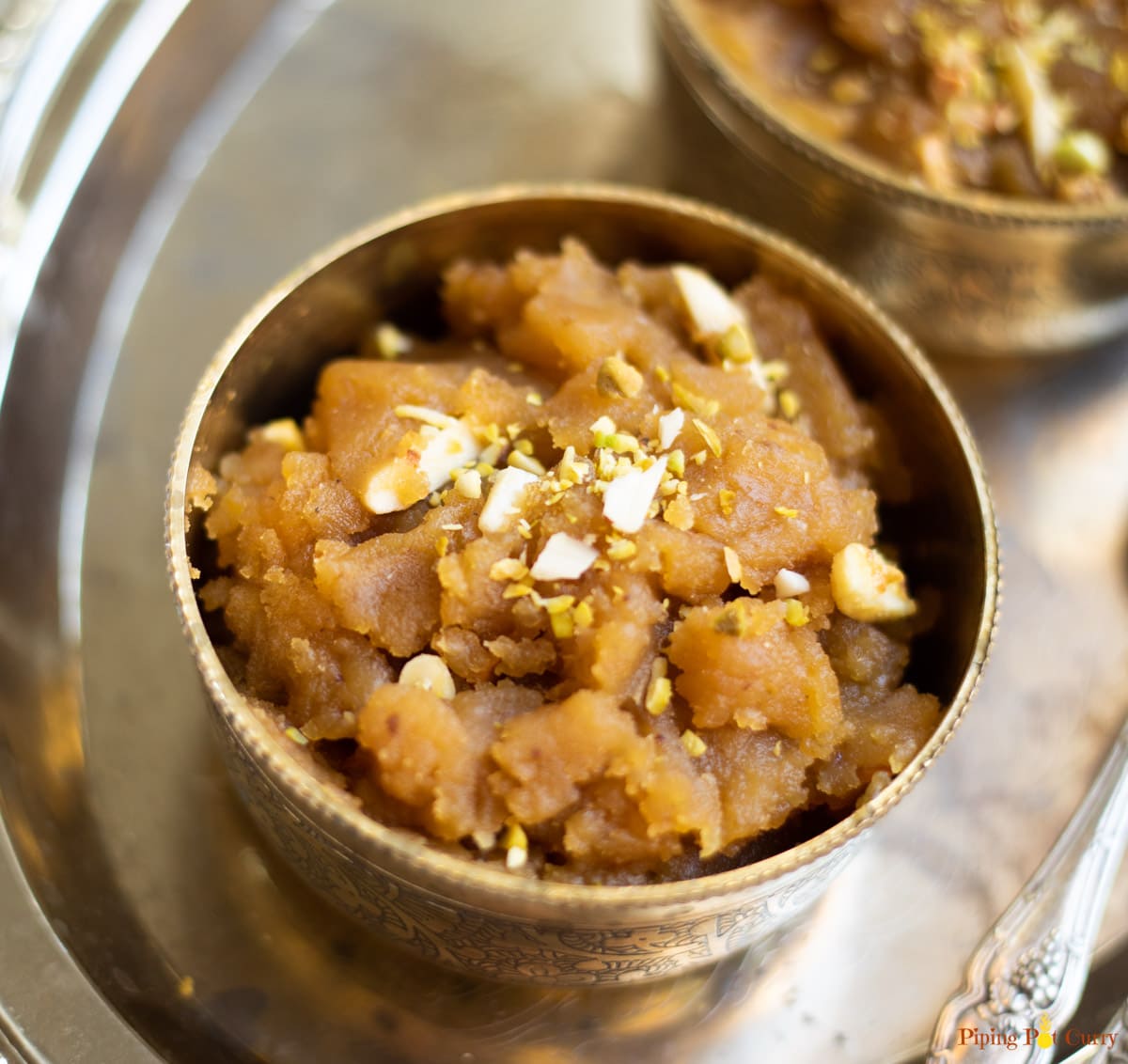 Moong Dal Halwa garnished with almonds and pistachios in pretty bowls. 
